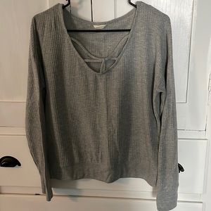 All grey long sleeve with cross ties along the chest.